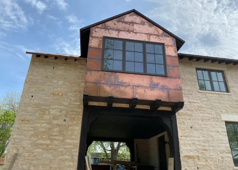 Copper metal panel facade on a stone building for Skylight Installation in DeKalb