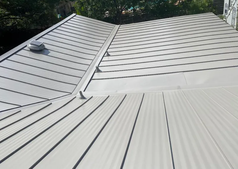 Solar attic fan installed on a metal roof for Roof Ventilation in DeKalb